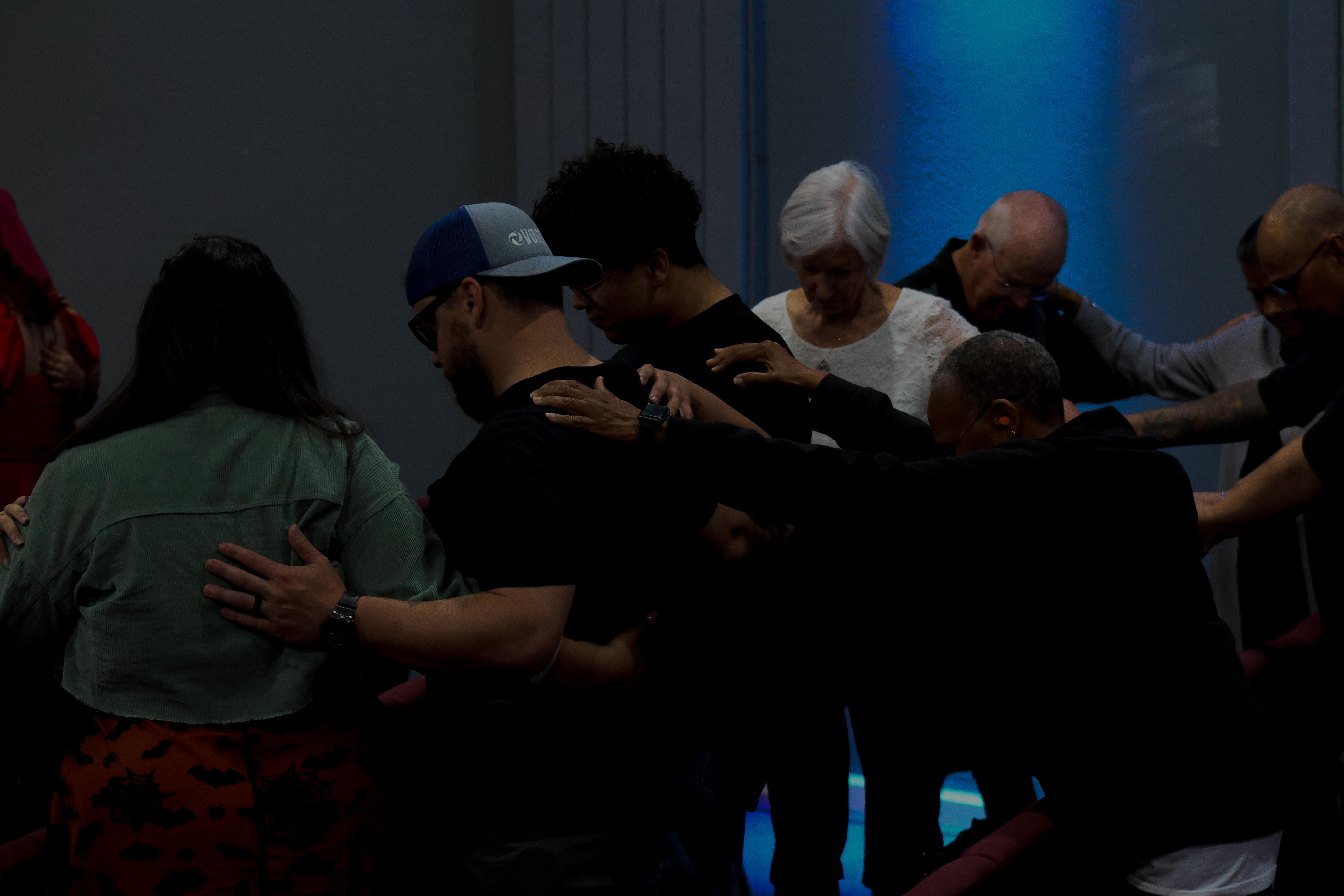 Community members praying together at Ethos Church