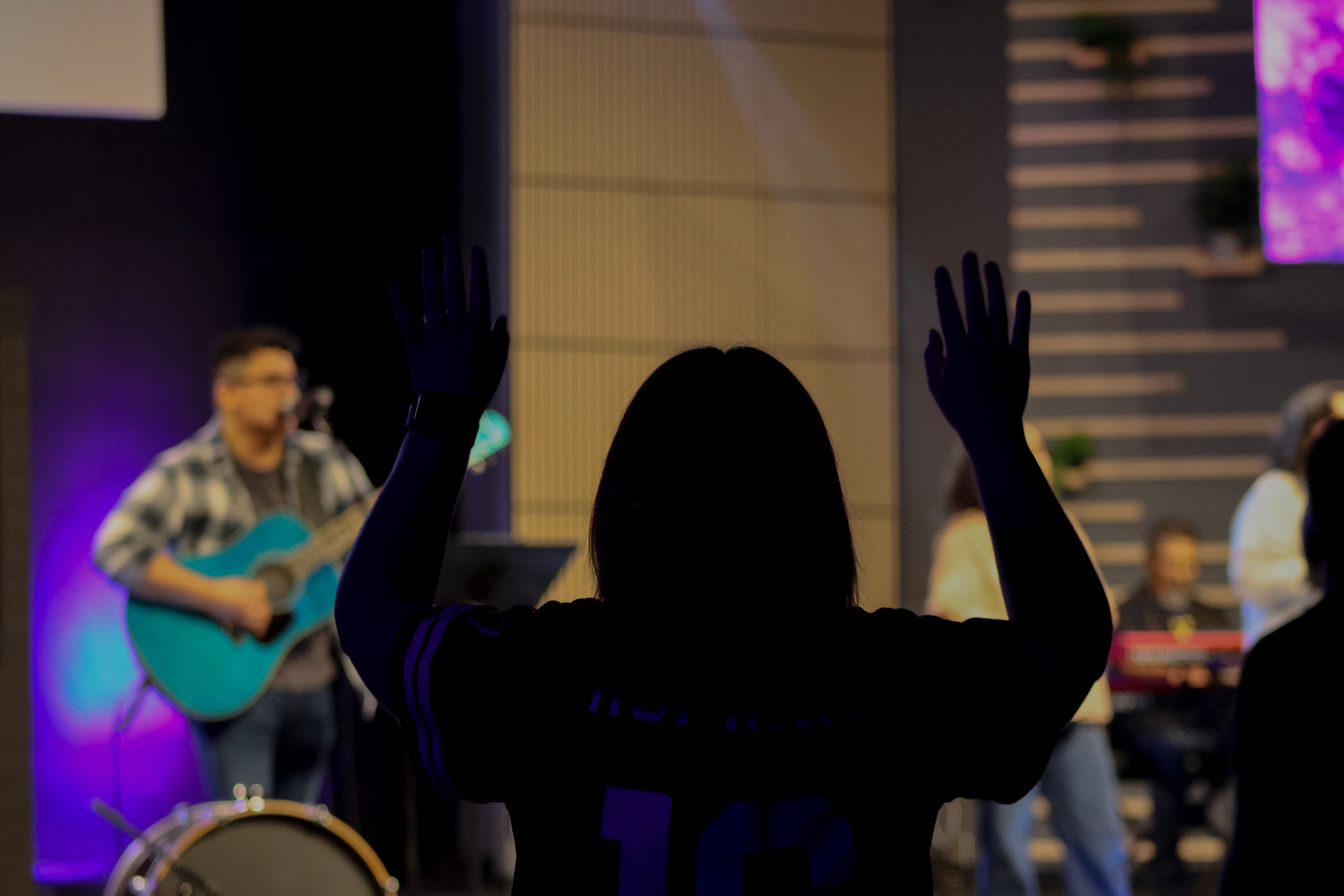 Child worshipping with hands raised